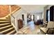 Inviting living room featuring exposed brick, staircase and comfortable seating at 1505 S Alabama St, Indianapolis, IN 46225