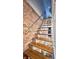 Open staircase featuring wooden treads with a brick accent wall at 1505 S Alabama St, Indianapolis, IN 46225