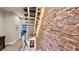 Floating staircase with wood treads and brick wall, leading to an upstairs bedroom at 1505 S Alabama St, Indianapolis, IN 46225