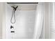Clean white bathroom features a black shower head and a sleek shower curtain at 1714 Elm St, Columbus, IN 47201
