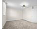 Carpeted bedroom with a flush mount light fixture, one window, and access to another room at 1714 Elm St, Columbus, IN 47201