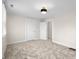 Neutral bedroom features plush carpet, a flush mount light fixture, and two closets with white paneled doors at 1714 Elm St, Columbus, IN 47201