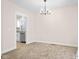Inviting dining room featuring neutral paint, plush carpeting, and a modern chandelier at 1714 Elm St, Columbus, IN 47201