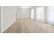 Spacious dining room with plush carpet, a chandelier, and three large windows at 1714 Elm St, Columbus, IN 47201