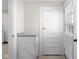 Hallway features a half bath with white cabinets and granite countertops at 1714 Elm St, Columbus, IN 47201