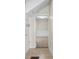 Hallway featuring coat hooks, neutral paint, and an open doorway to the next room at 1714 Elm St, Columbus, IN 47201