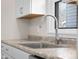Close up of the kitchen sink, faucet, countertop, and white cabinetry at 1714 Elm St, Columbus, IN 47201