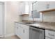 Charming kitchen featuring white cabinets, stainless steel appliances, and light countertops at 1714 Elm St, Columbus, IN 47201