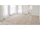 Bright living room featuring plush carpeting, large windows with white curtains and white trim at 1714 Elm St, Columbus, IN 47201