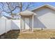 Backyard view of detached building with door and vinyl siding, adjacent to the fenced yard at 1714 Elm St, Columbus, IN 47201