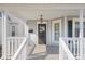 Close-up view of a charming covered porch with decorative railings and a hanging lantern at 1714 Elm St, Columbus, IN 47201
