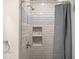 Tiled shower with built-in shelving and modern fixtures at 1714 Elm St, Columbus, IN 47201