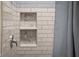 Close up of a tiled shower with built-in shelving at 1714 Elm St, Columbus, IN 47201