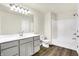 Bright bathroom featuring gray vanity, white countertop, stylish lighting, and tub-shower combo at 19493 Grassy Branch Rd, Westfield, IN 46074