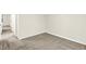 A carpeted room with white walls and trim; hallway visible from the doorway at 19493 Grassy Branch Rd, Westfield, IN 46074