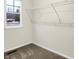 The bedroom closet has metal shelving and a double-hung window overlooking the exterior landscape at 19493 Grassy Branch Rd, Westfield, IN 46074