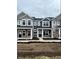 Street view showcasing charming new construction townhomes, each with unique colors and inviting front porches at 19493 Grassy Branch Rd, Westfield, IN 46074