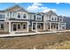 A row of townhouses with a mix of stone and siding exteriors on a sunny day at 19493 Grassy Branch Rd, Westfield, IN 46074