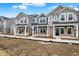 Newly constructed townhouses with stone accents, multiple windows, and landscaped surroundings at 19493 Grassy Branch Rd, Westfield, IN 46074