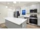 Bright kitchen features gray cabinets, a large island, and stainless steel appliances at 19493 Grassy Branch Rd, Westfield, IN 46074