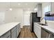 Features modern gray cabinets, stainless steel appliances, and an island with quartz countertops at 19493 Grassy Branch Rd, Westfield, IN 46074