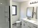 Well-lit bathroom featuring a double sink vanity, shower with glass door and black hardware at 19533 Justin Morgan Dr, Westfield, IN 46074
