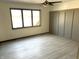 Spacious bedroom featuring a ceiling fan, natural light and gray vinyl plank flooring at 19533 Justin Morgan Dr, Westfield, IN 46074