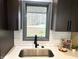 Kitchen sink with a modern faucet and a view of the greenery outside at 19533 Justin Morgan Dr, Westfield, IN 46074