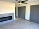 Open living area with modern gray accent fireplace, two closet, and neutral flooring at 19533 Justin Morgan Dr, Westfield, IN 46074