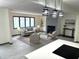 Open-concept living room with fireplace, large windows, and modern decor at 19533 Justin Morgan Dr, Westfield, IN 46074
