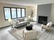 Cozy living room featuring a fireplace, large windows, and comfortable seating at 19533 Justin Morgan Dr, Westfield, IN 46074