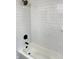 Close-up of a shower with white subway tile, black fixtures, and a white bathtub with black drain at 19533 Justin Morgan Dr, Westfield, IN 46074