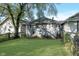 Cozy home backyard with green lawn, wood fence, and access to the house at 2433 Indianapolis Ave, Indianapolis, IN 46208