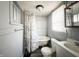 Classic bathroom with a tub, toilet, and ample natural light at 2433 Indianapolis Ave, Indianapolis, IN 46208