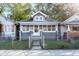 Charming single-story home featuring a welcoming porch and fenced front yard at 2433 Indianapolis Ave, Indianapolis, IN 46208
