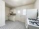 Functional kitchen with white cabinetry, patterned floors, and natural light at 2433 Indianapolis Ave, Indianapolis, IN 46208