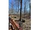 View of the backyard with mature trees and a deck at 28 Cambridge Ct, Anderson, IN 46012