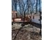 View of the backyard with mature trees and a deck at 28 Cambridge Ct, Anderson, IN 46012