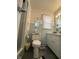 Standard bathroom with blue tiled walls and a white toilet and sink at 28 Cambridge Ct, Anderson, IN 46012