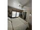 Bedroom with a ceiling fan, a window with blinds, and a white dresser at 28 Cambridge Ct, Anderson, IN 46012