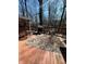 Relaxing deck with grill, rug, and chairs overlooking a wooded area at 28 Cambridge Ct, Anderson, IN 46012