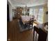 Sunlit dining room featuring hardwood floors, piano and classic decor at 28 Cambridge Ct, Anderson, IN 46012
