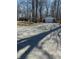 Exterior view of the home with a detached garage and gravel driveway at 28 Cambridge Ct, Anderson, IN 46012