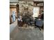A brick fireplace with a wooden mantel and black fireplace door at 28 Cambridge Ct, Anderson, IN 46012