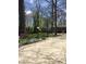 Inviting front yard with lush greenery, mature trees, and a basketball hoop for outdoor enjoyment at 28 Cambridge Ct, Anderson, IN 46012