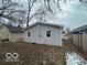 A view of the backyard shows vinyl siding on a home with a newly installed window at 2912 N Gladstone Ave, Indianapolis, IN 46218