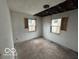 Bedroom in need of repair, with boarded windows and some ceiling damage at 2912 N Gladstone Ave, Indianapolis, IN 46218