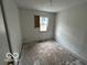 Bedroom awaiting renovation with a boarded window and blank walls, ready for customization at 2912 N Gladstone Ave, Indianapolis, IN 46218
