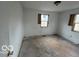 Bedroom in need of renovation with boarded windows and blank walls ready for customization at 2912 N Gladstone Ave, Indianapolis, IN 46218