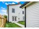 A backyard featuring a well-manicured lawn, white siding, black trim, and a new AC unit at 35 N Keystone Ave, Indianapolis, IN 46201